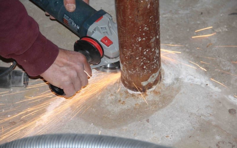 Cutting off Lally columns angle grinder