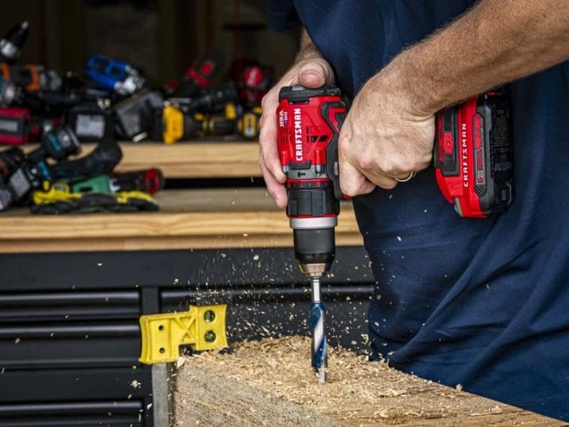 auger bit drilling into layered OSB