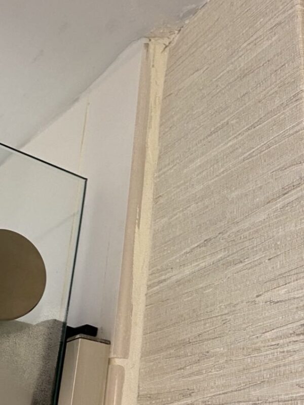 Double layer tile grout along wallpaper