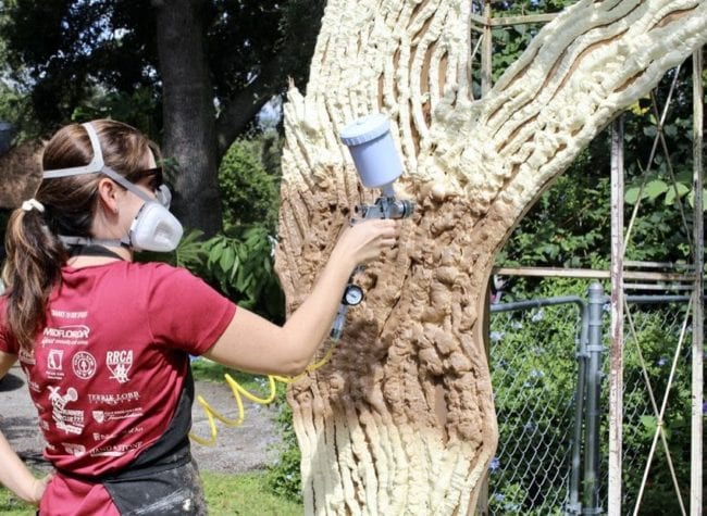 spray painting foam covered tree