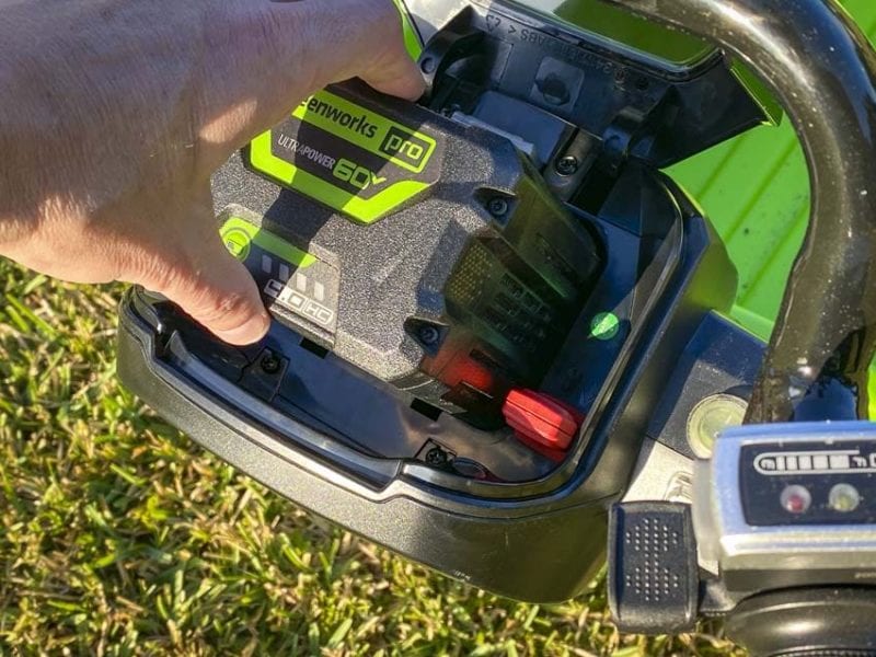 inserting Greenworks 60V battery pack