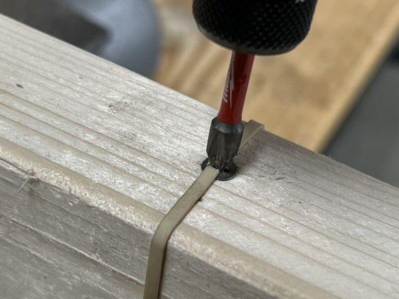 using a rubber band to remove a stripped screw